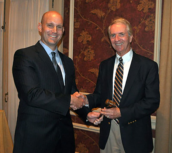 Mike Glezer accepts the gavel from Richard Wagman