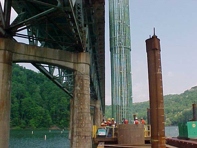 Putting steel reinfocing cage with CSC guide wheels in steel casing Rebar cage